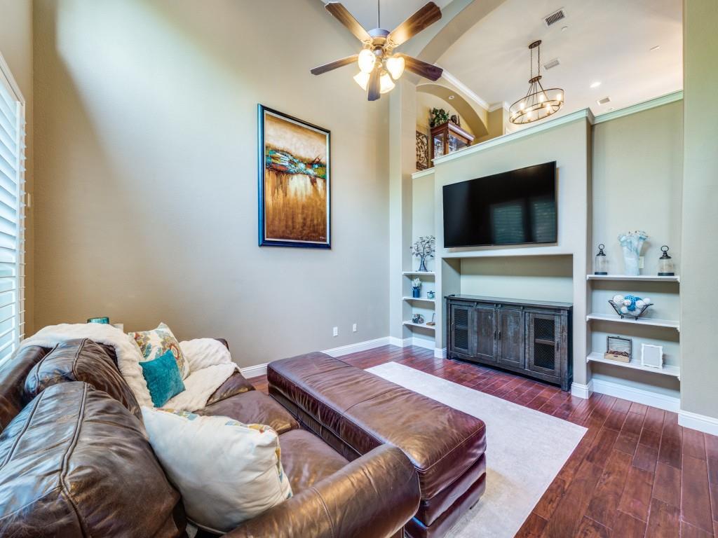5721 Lunsford Road Plano, TX 75024 - Photo 4 of 17 a living room with furniture a flat screen tv and a fireplace