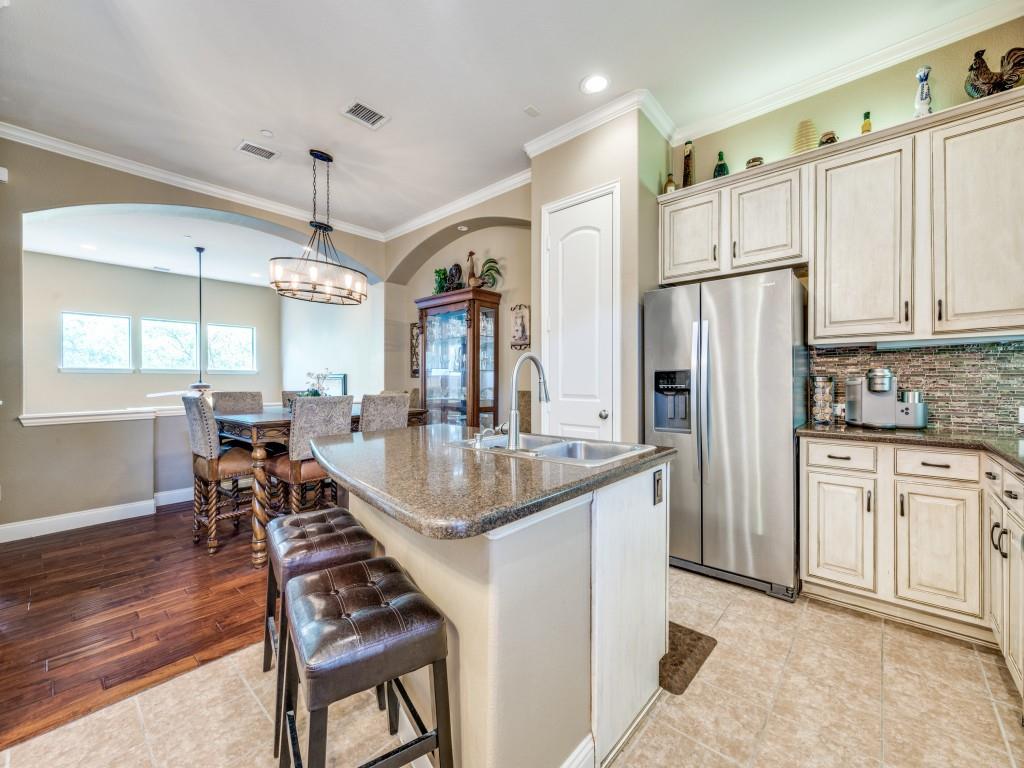 5721 Lunsford Road Plano, TX 75024 - Photo 7 of 17 a kitchen with stainless steel appliances granite countertop a refrigerator a sink dishwasher a stove and white cabinets with wooden floor