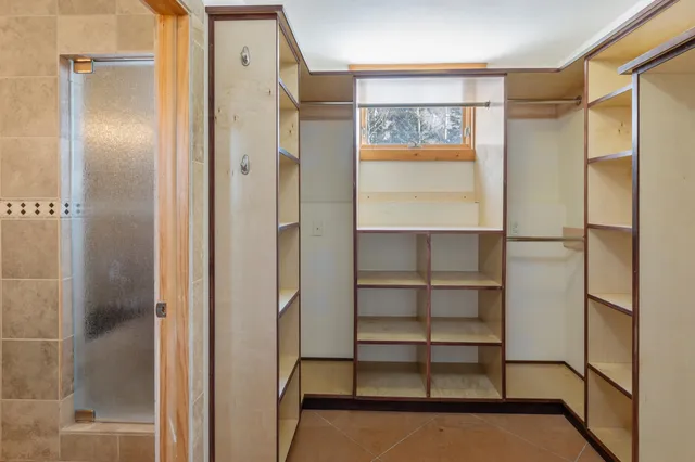 a bathroom with a glass shower door and a bathtub