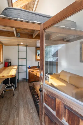 a living room with furniture a window and wooden floor