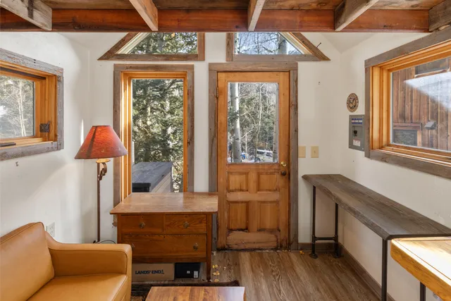 a bedroom with furniture and a large window