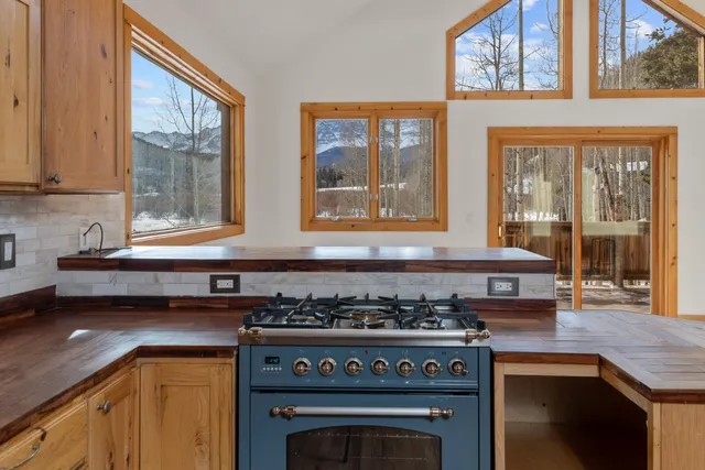 a kitchen with stainless steel appliances granite countertop a stove and a microwave