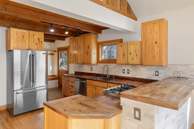 a kitchen with a sink a refrigerator and a stove