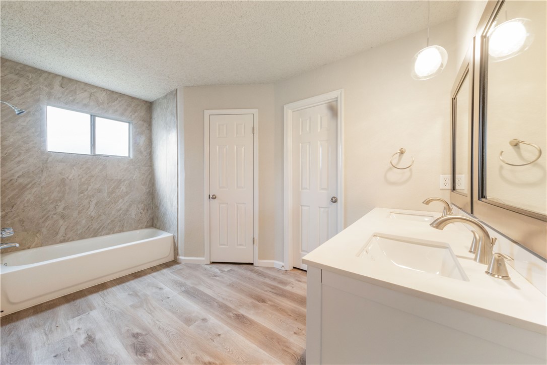 3901 Skipton Drive Austin, TX 78727 - Photo 11 of 21 a bathroom with a bathtub and a sink