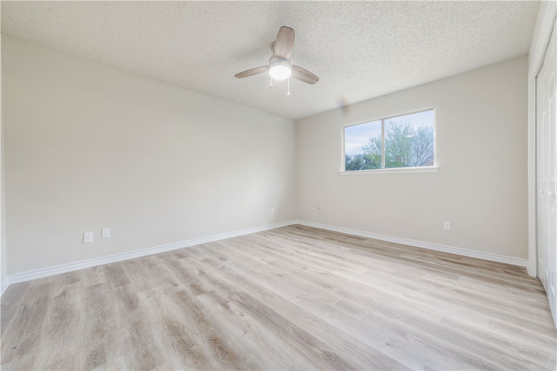 3901 Skipton Drive Austin, TX 78727 - Photo 13 of 21 a view of an empty room with wooden floor and a window