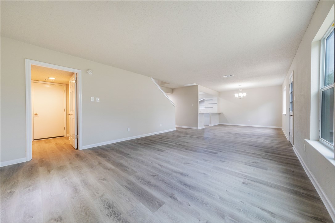 3901 Skipton Drive Austin, TX 78727 - Photo 3 of 21 wooden floor in an empty room with a window