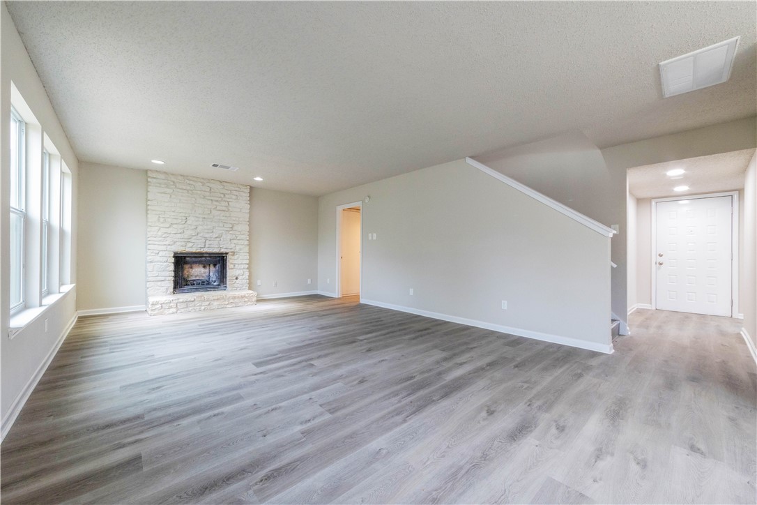 3901 Skipton Drive Austin, TX 78727 - Photo 5 of 21 a view of empty room with wooden floor and window