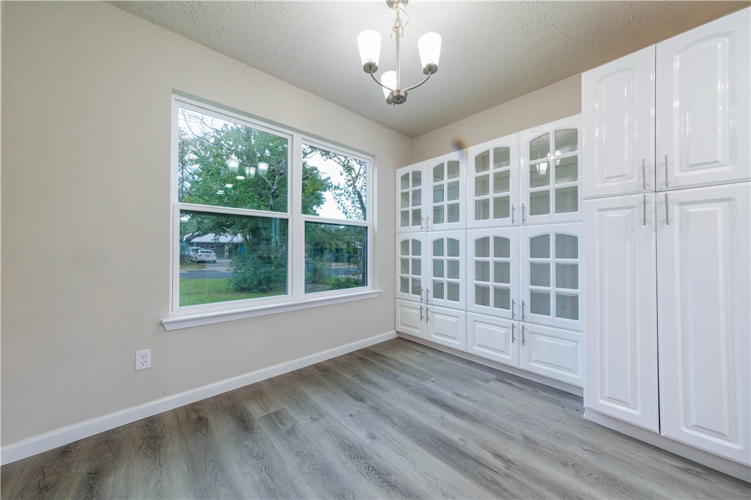 3901 Skipton Drive Austin, TX 78727 - Photo 8 of 21 an empty room with wooden floor and windows