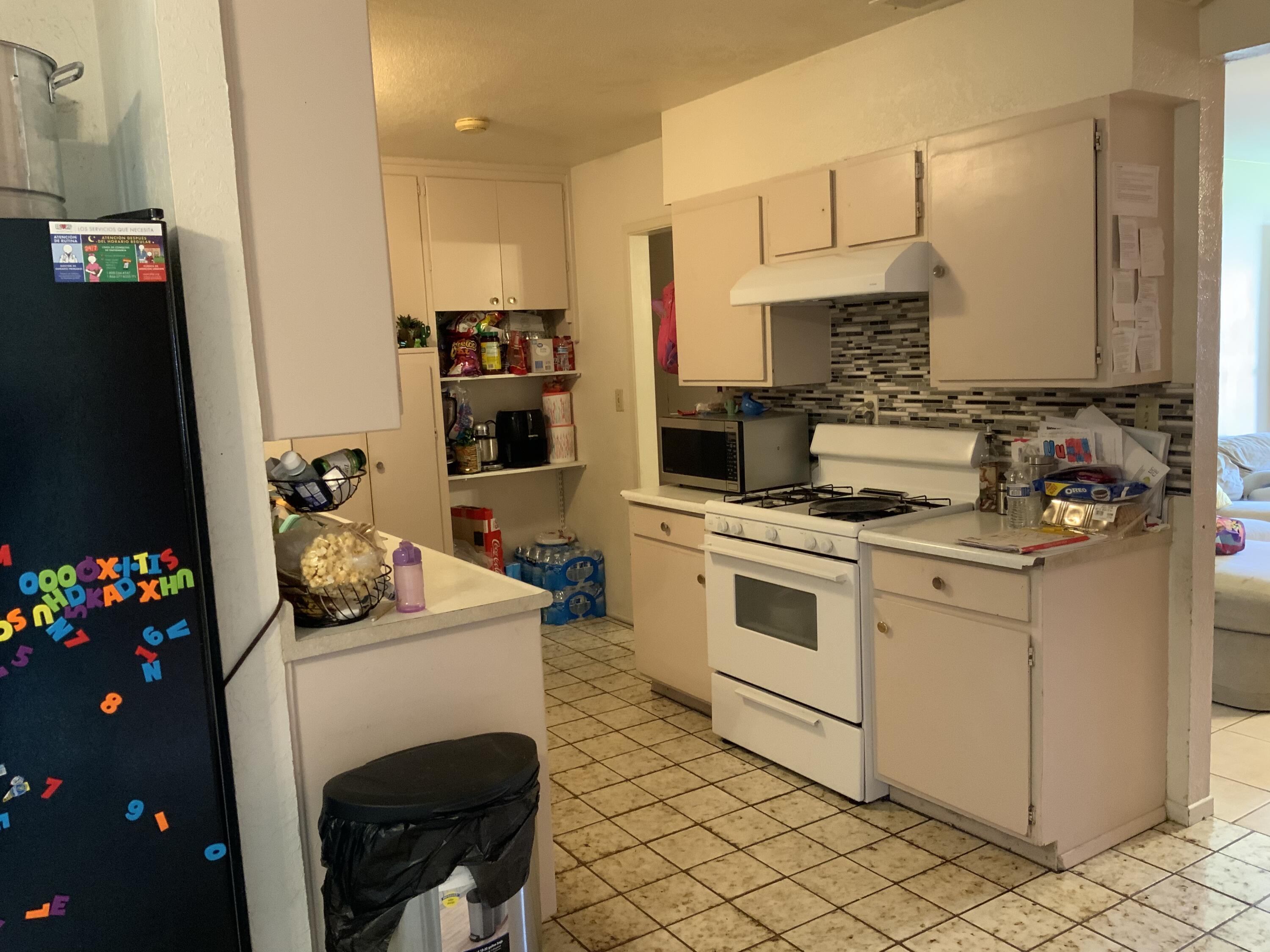 46600 Vargas Road Indio, CA 92201 - Photo 6 of 23 a kitchen with stainless steel appliances white cabinets and a stove top oven