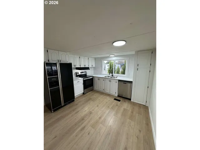 a kitchen with stainless steel appliances a refrigerator and a sink