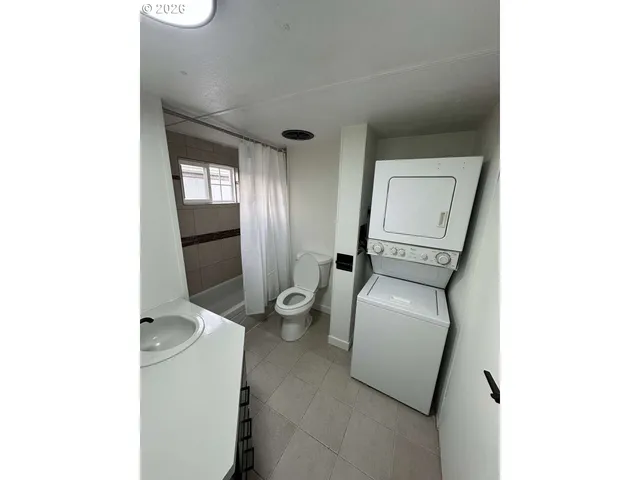 a living room with furniture and a toilet