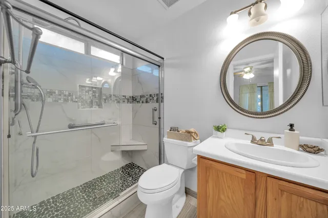 a kitchen with stainless steel appliances granite countertop a sink a stove top oven a counter space and cabinets