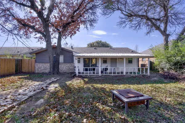 a view of a house with a yard patio and fire pit