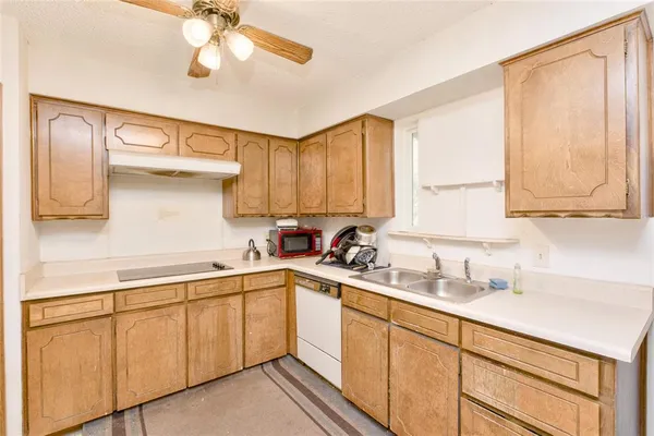 a kitchen with a sink cabinets and window