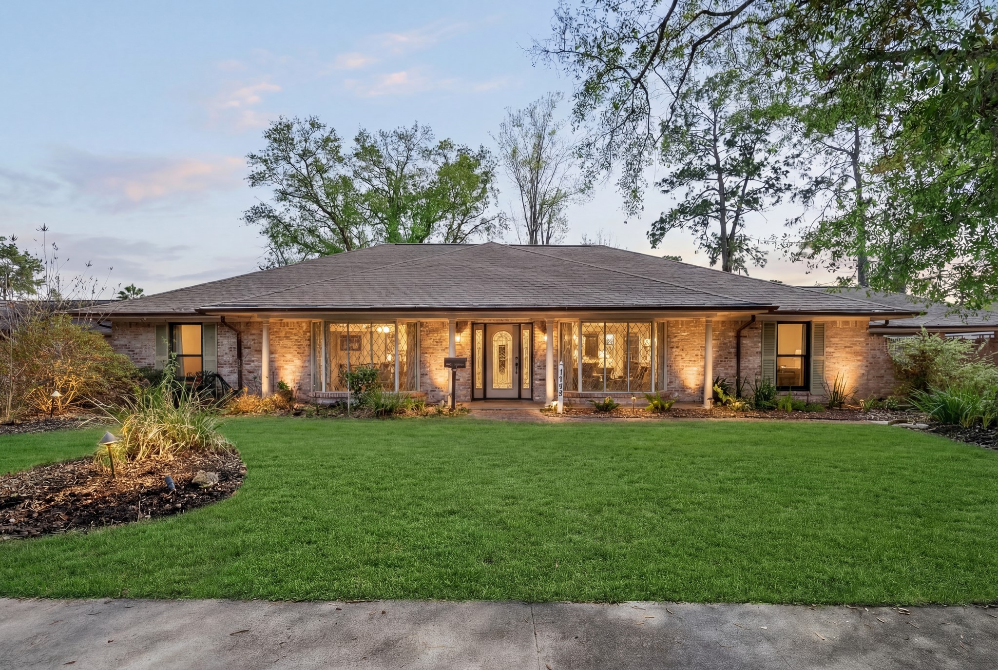 a front view of a house with a garden