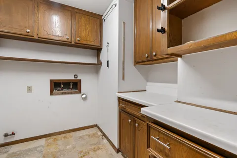 a view of a storage and utility room with washer and dryer