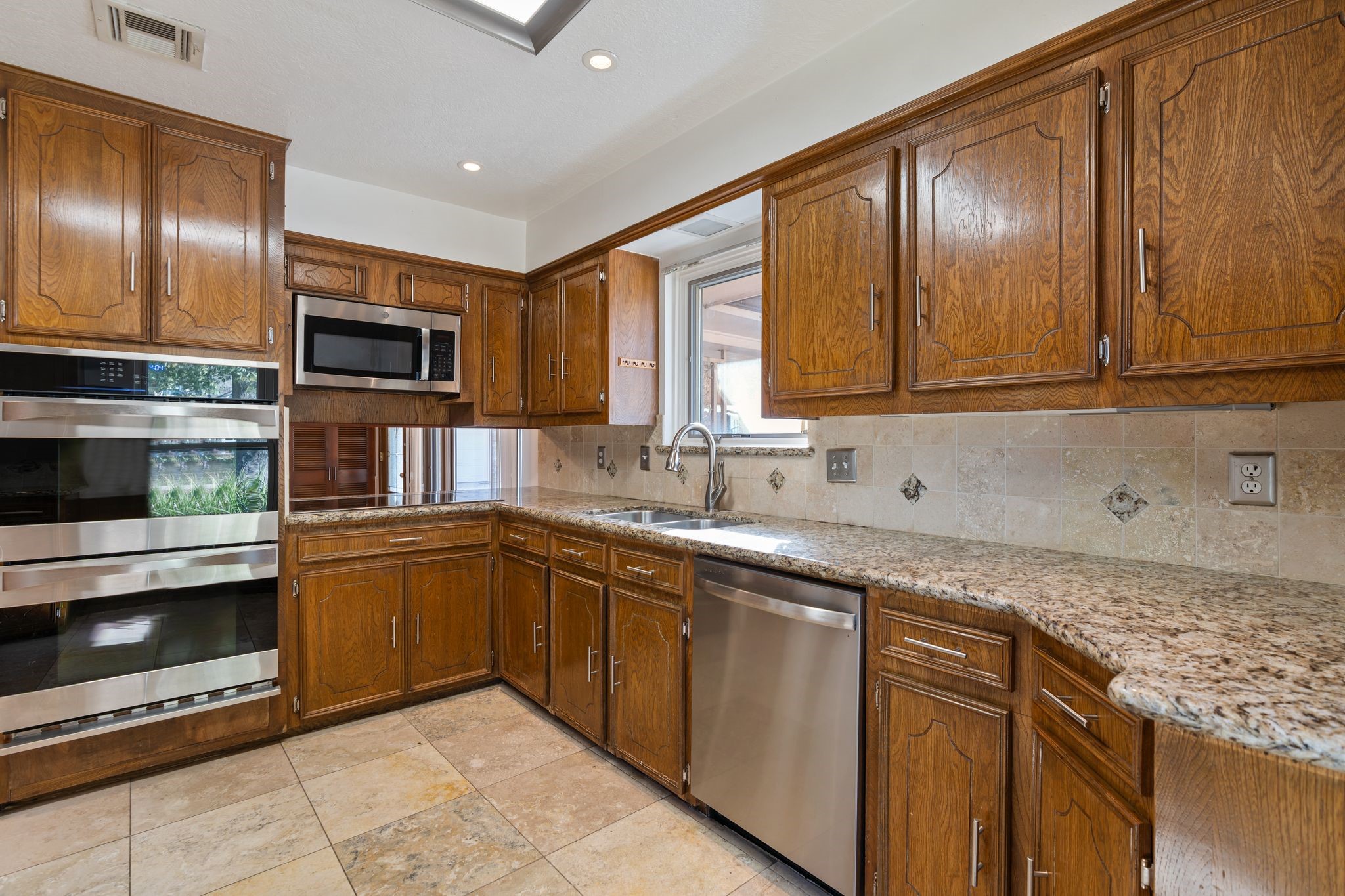 1043 Martin Street Houston, TX 77018 - Photo 14 of 45 a kitchen with granite countertop stainless steel appliances and cabinets