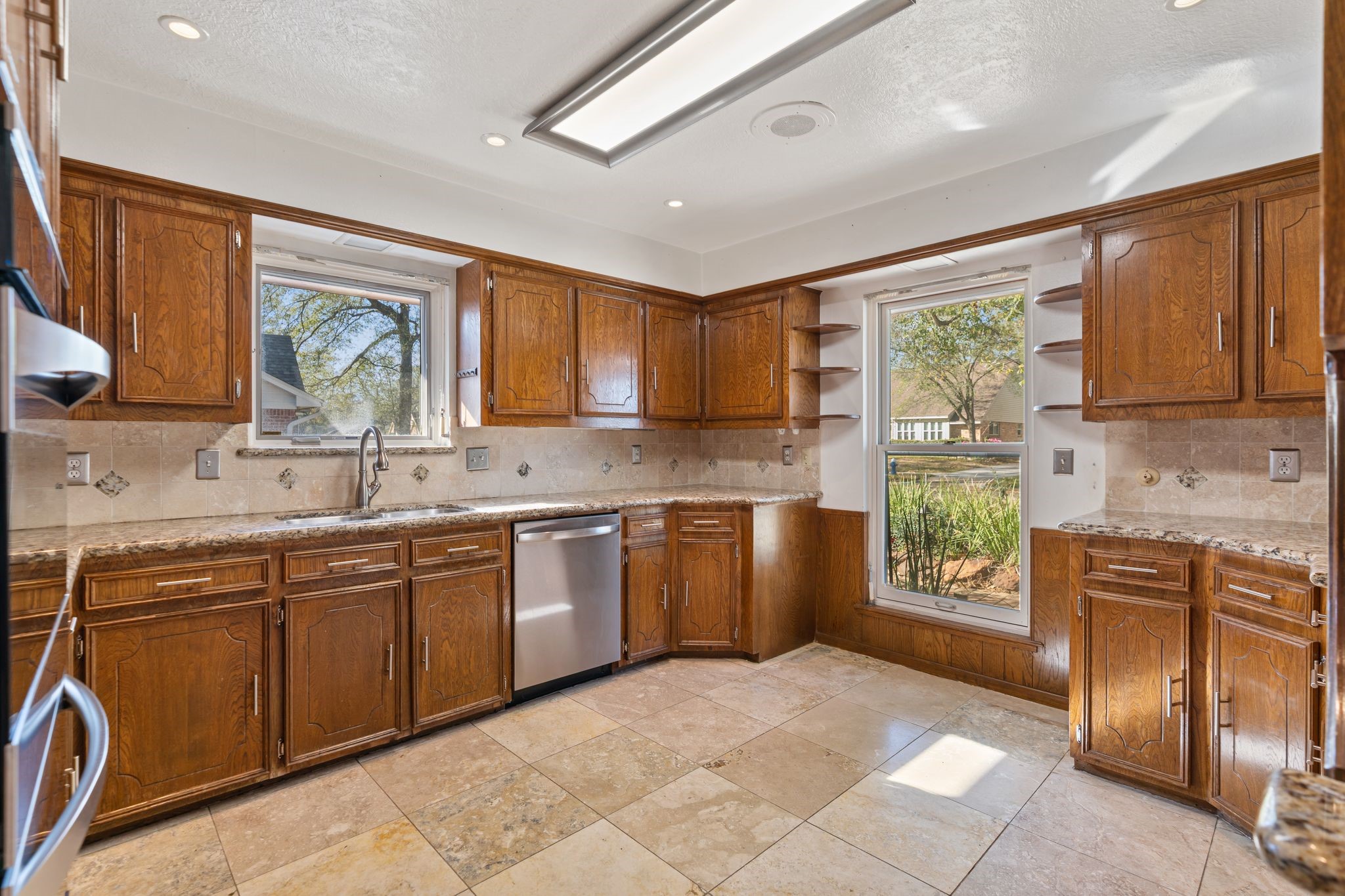 1043 Martin Street Houston, TX 77018 - Photo 15 of 45 a kitchen with stainless steel appliances granite countertop a stove sink and cabinets
