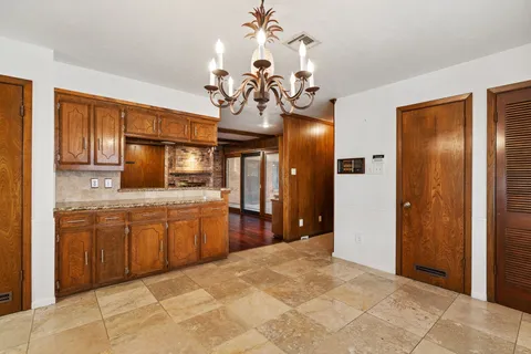 a spacious bathroom with a granite countertop sink a mirror and a shower