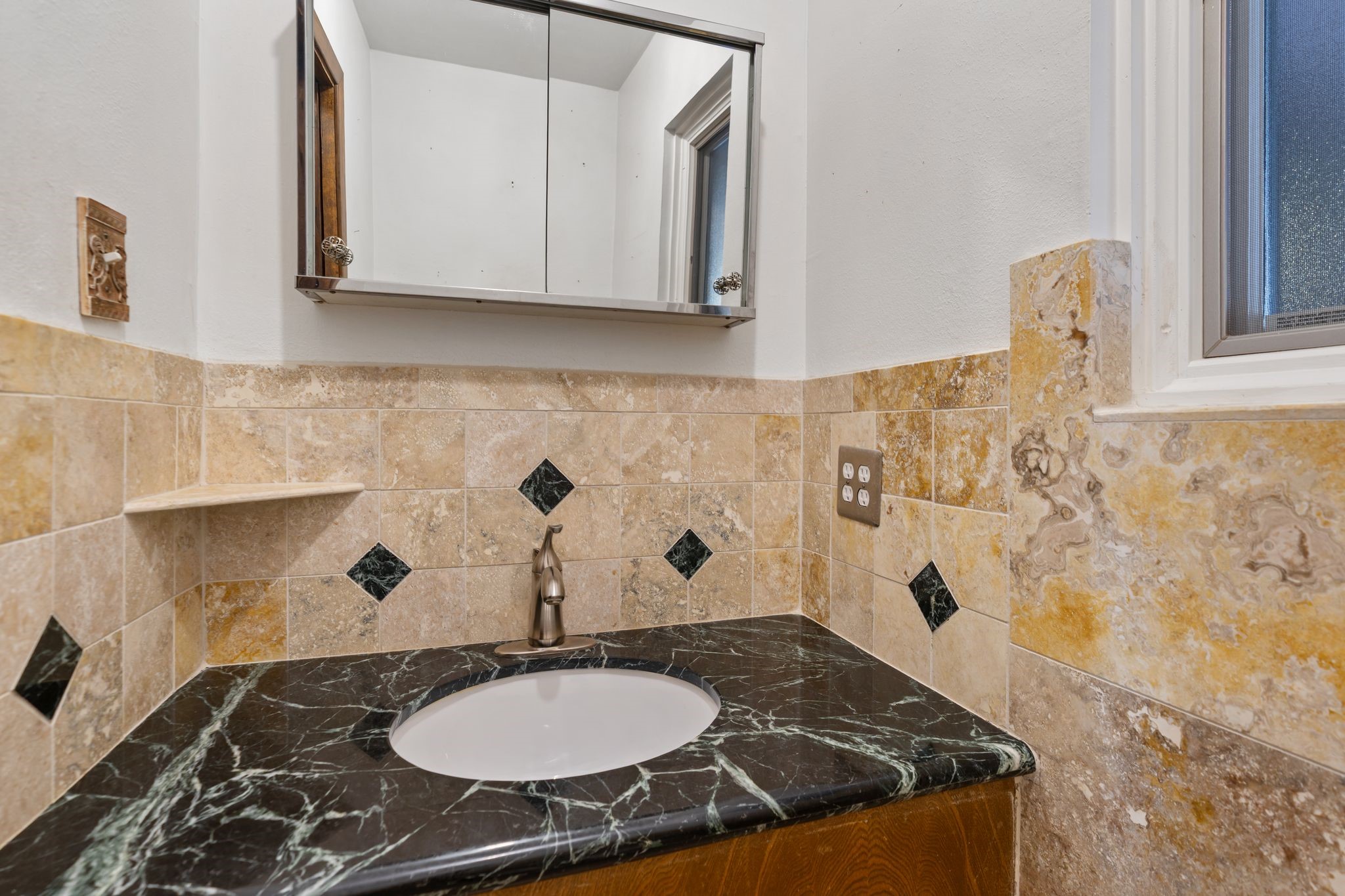 1043 Martin Street Houston, TX 77018 - Photo 21 of 45 a bathroom with a granite countertop sink and a mirror