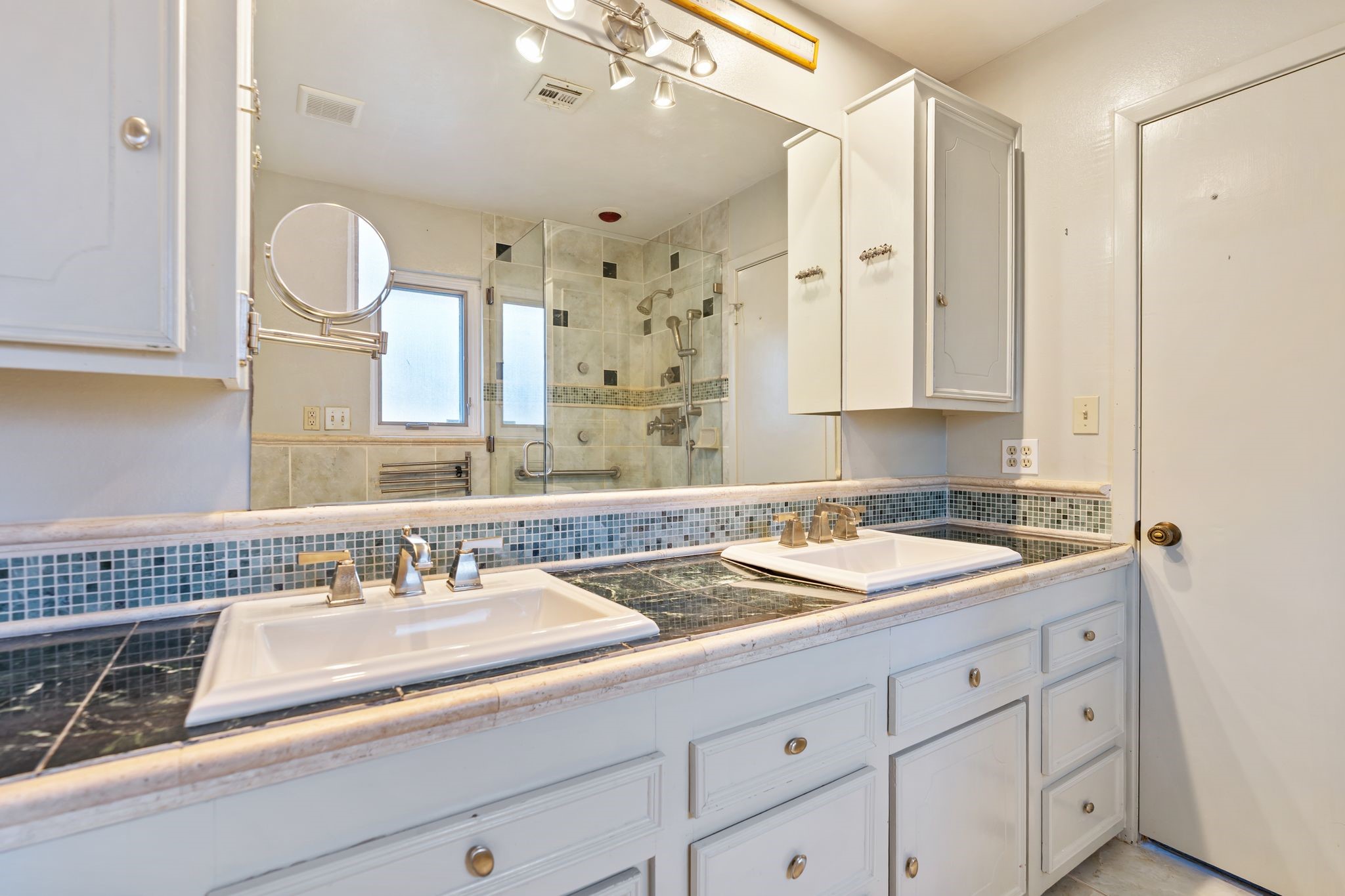 1043 Martin Street Houston, TX 77018 - Photo 25 of 45 a bathroom with a granite countertop sink a mirror and a