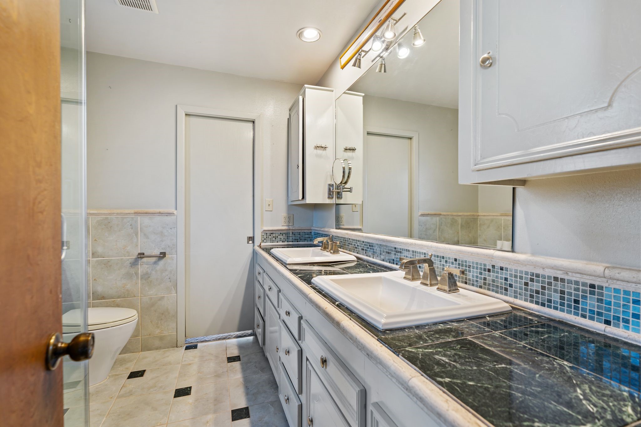 1043 Martin Street Houston, TX 77018 - Photo 27 of 45 a bathroom with a granite countertop sink a mirror and a shower