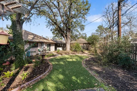 a backyard of a house with yard and outdoor seating