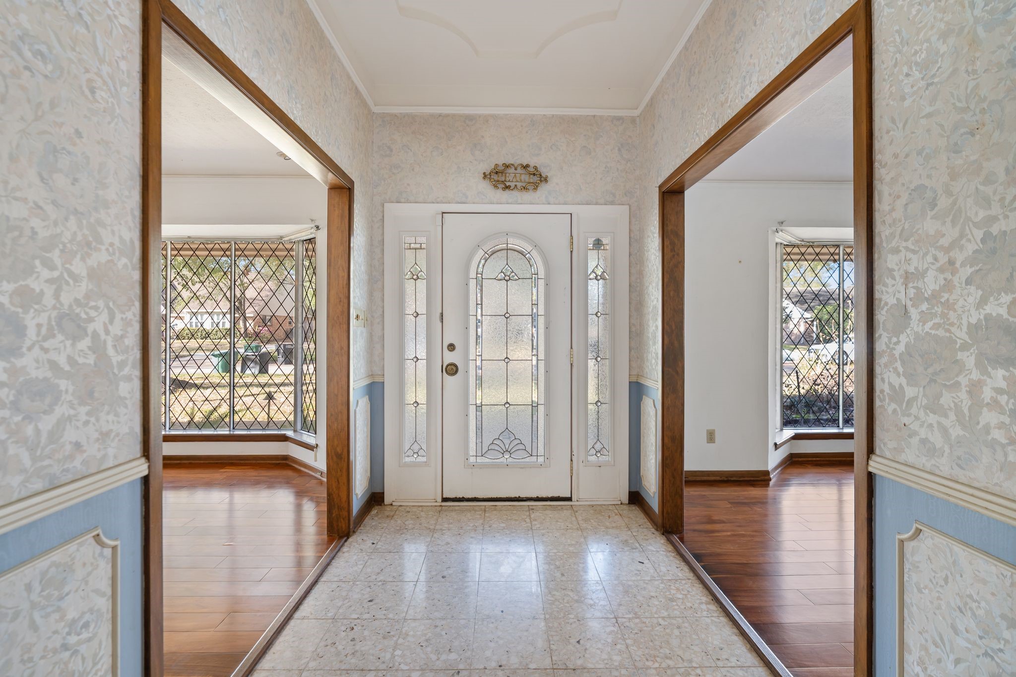 1043 Martin Street Houston, TX 77018 - Photo 8 of 45 a view of a hallway with wooden floor and a livingroom with furniture