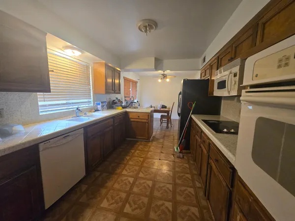 a kitchen with a sink a stove and cabinets
