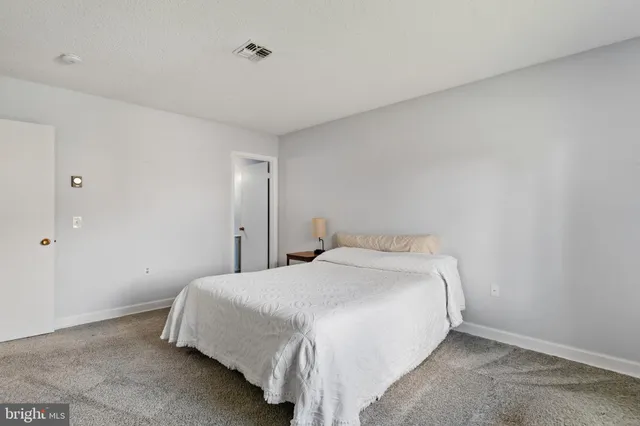 a bedroom with a bed and a night stand