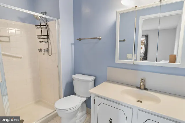 a white toilet sitting next to a bathroom sink