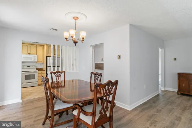 a view of a dining room with furniture and chandelier
