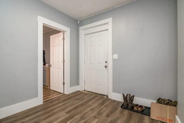 an empty room with wooden floor and closet