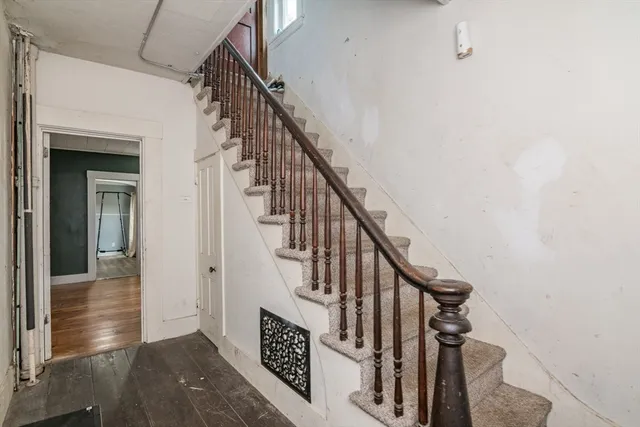 a view of entryway and hall with wooden floor