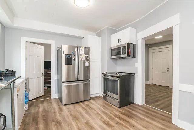 a kitchen with stainless steel appliances granite countertop a refrigerator and a stove top oven