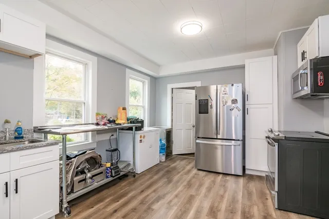 a kitchen with a refrigerator and a sink