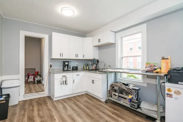 a kitchen with a white stove top oven and white cabinets