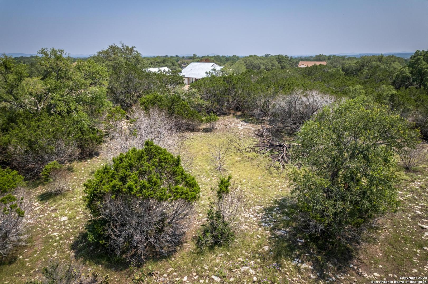 Lot 12 Rio Azul Pipe Creek, TX 78063 - Photo 24 of 30 a view of a garden with a building in background