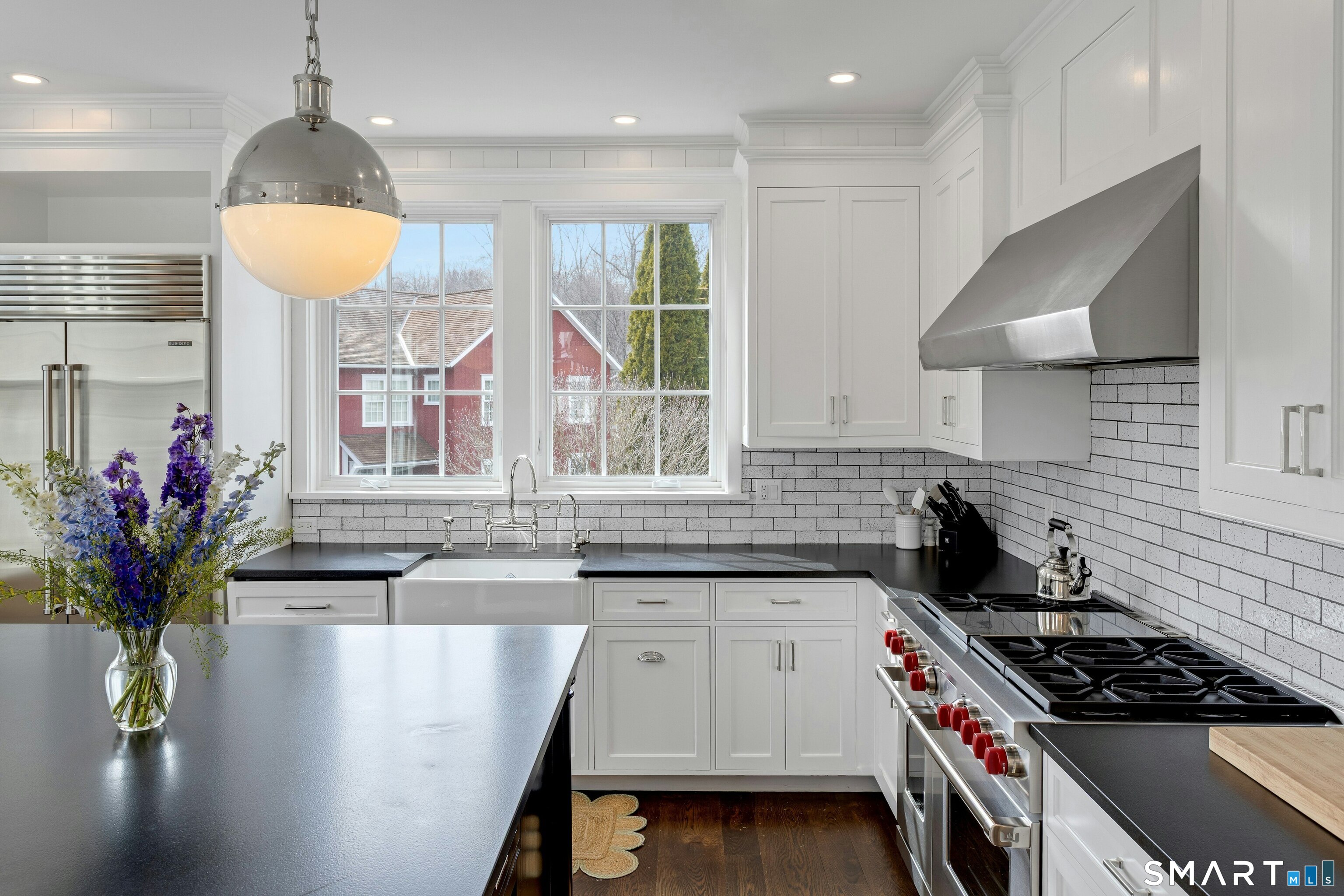 45 Jelliff Mill Road, Unit 45 New Canaan, CT 06840 - Photo 12 of 36 a kitchen with stainless steel appliances granite countertop a sink a stove and a wooden floors