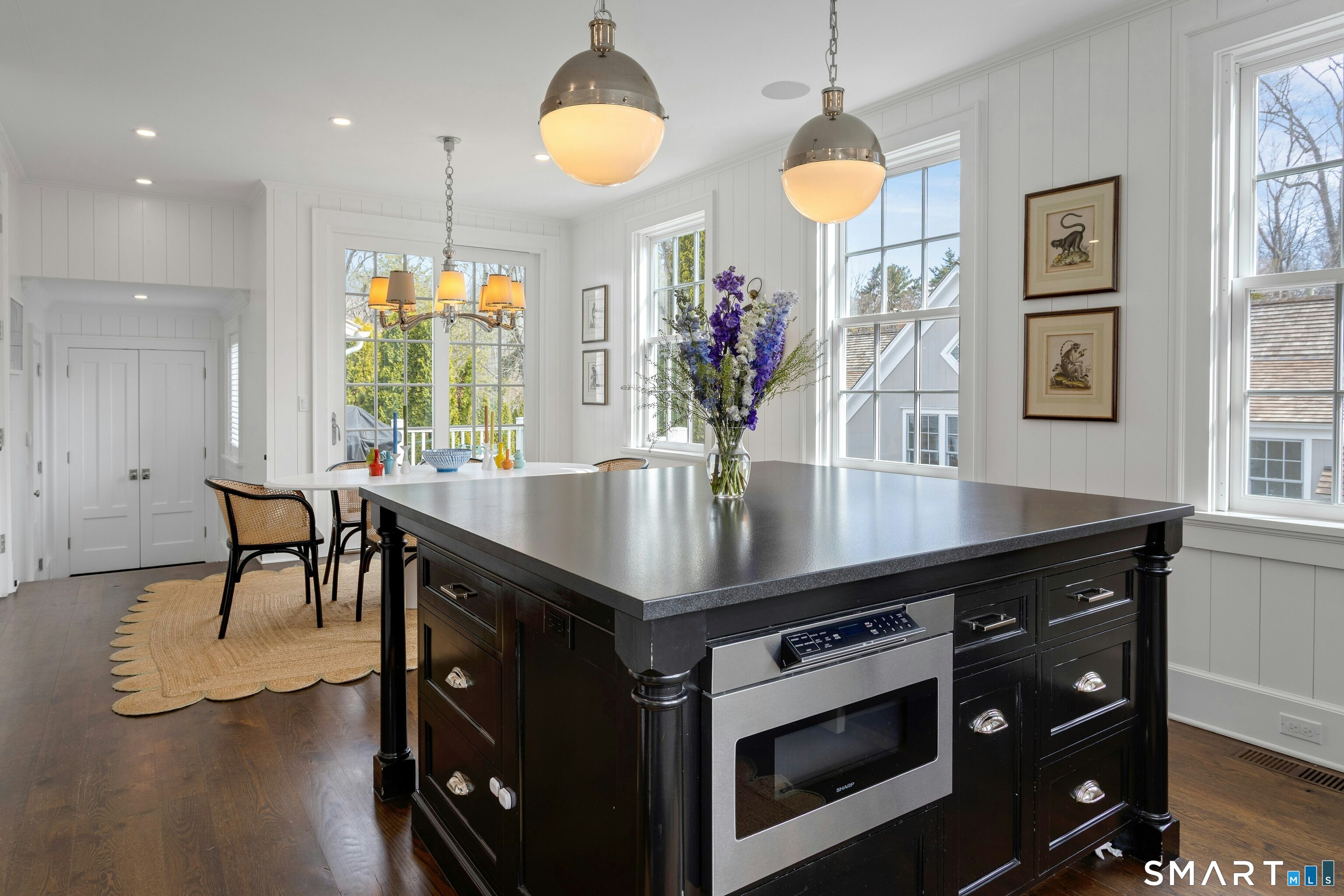 45 Jelliff Mill Road, Unit 45 New Canaan, CT 06840 - Photo 13 of 36 a kitchen with stainless steel appliances granite countertop a table chairs and a large window