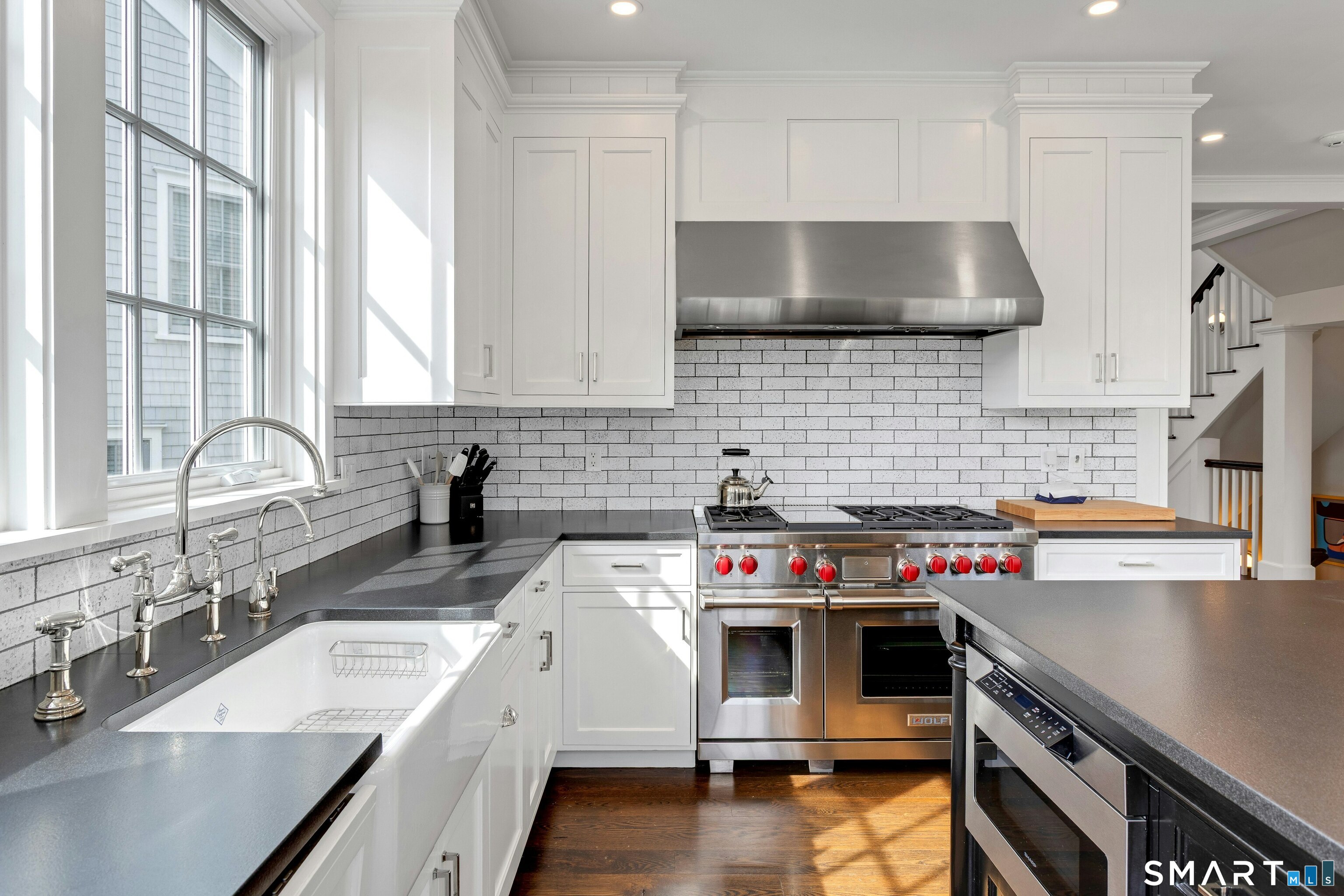 45 Jelliff Mill Road, Unit 45 New Canaan, CT 06840 - Photo 14 of 36 a kitchen with a sink stove top oven and cabinets