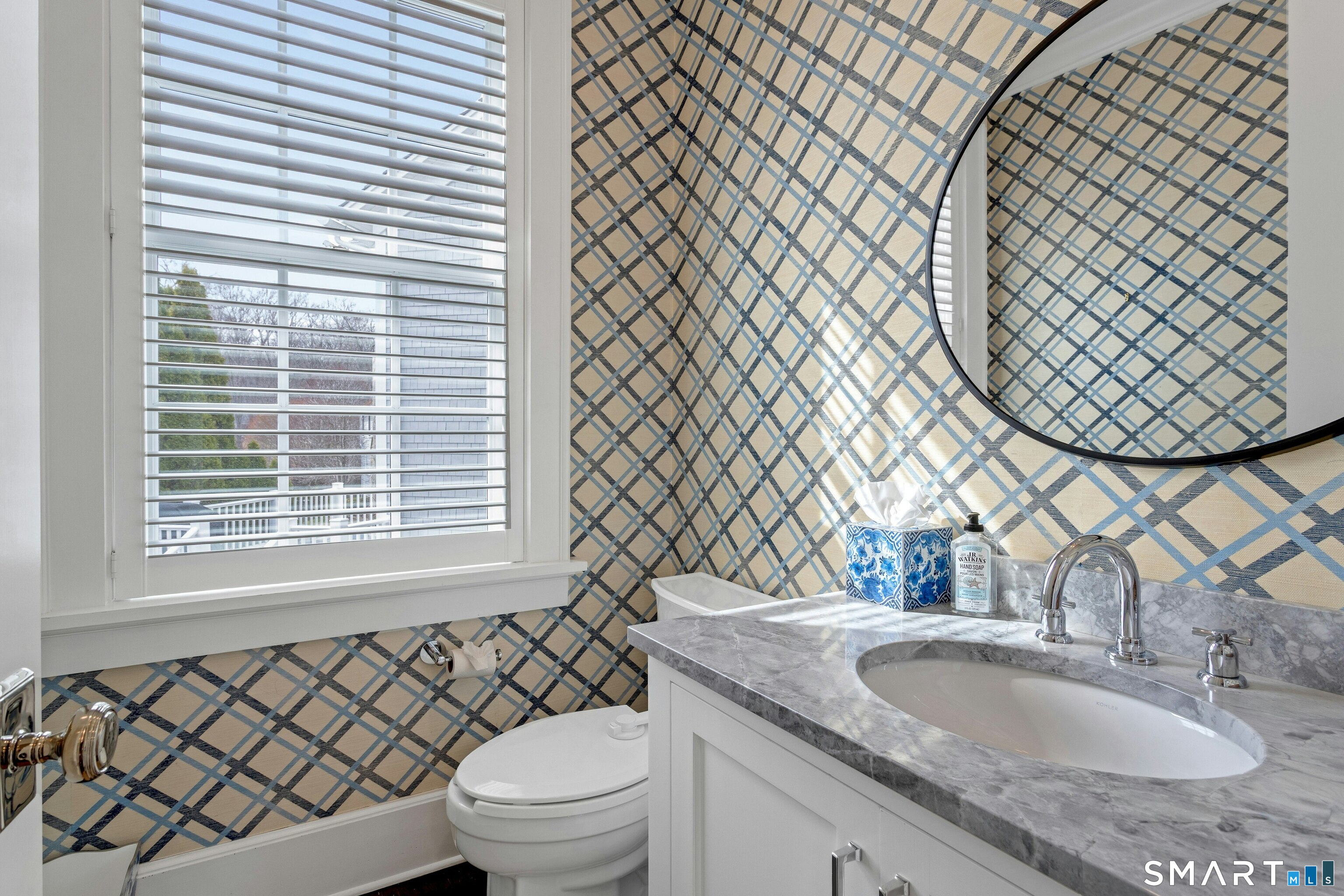 45 Jelliff Mill Road, Unit 45 New Canaan, CT 06840 - Photo 15 of 36 a bathroom with a granite countertop toilet a sink and a mirror
