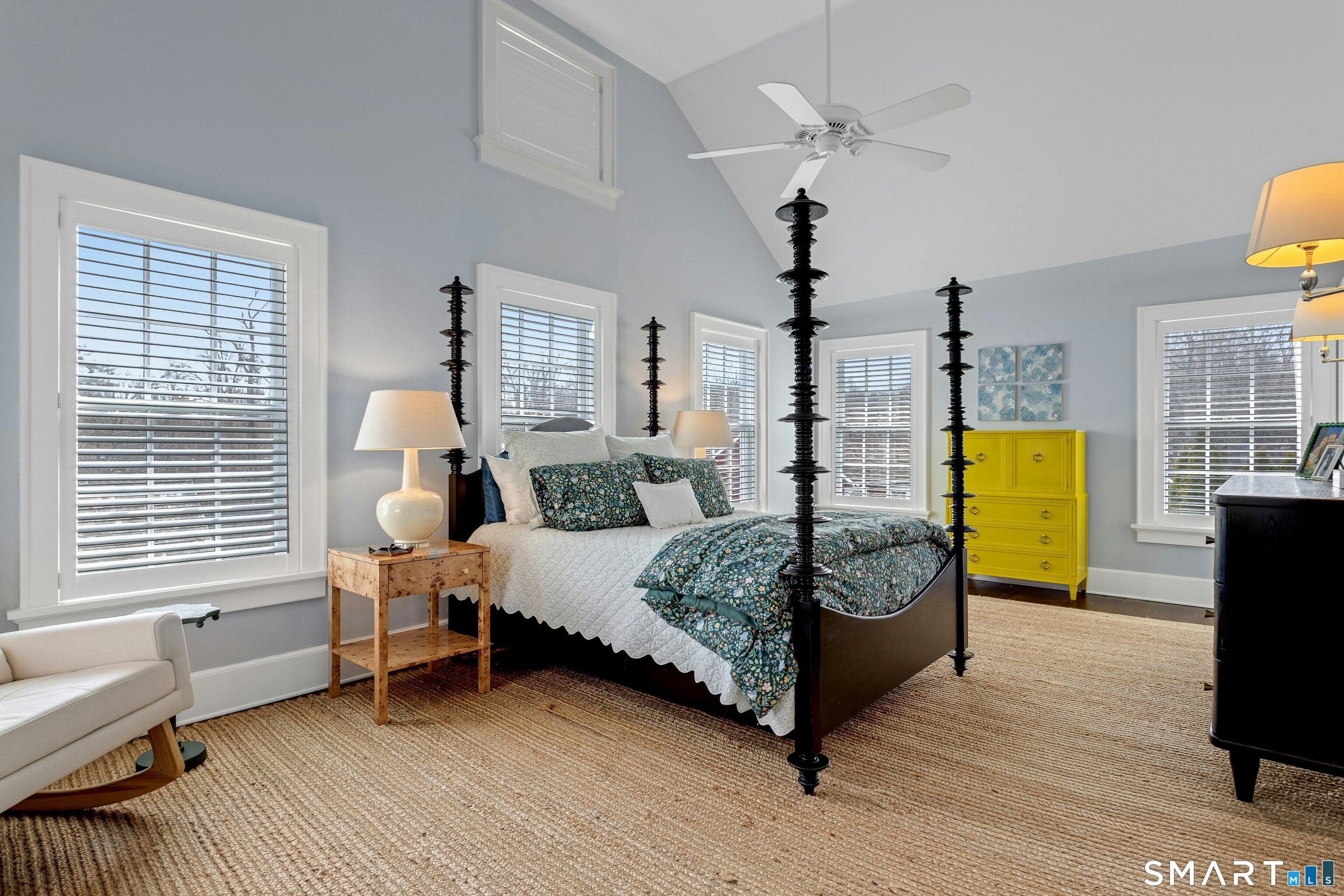 45 Jelliff Mill Road, Unit 45 New Canaan, CT 06840 - Photo 17 of 36 a bedroom with a bed a chandelier and dresser