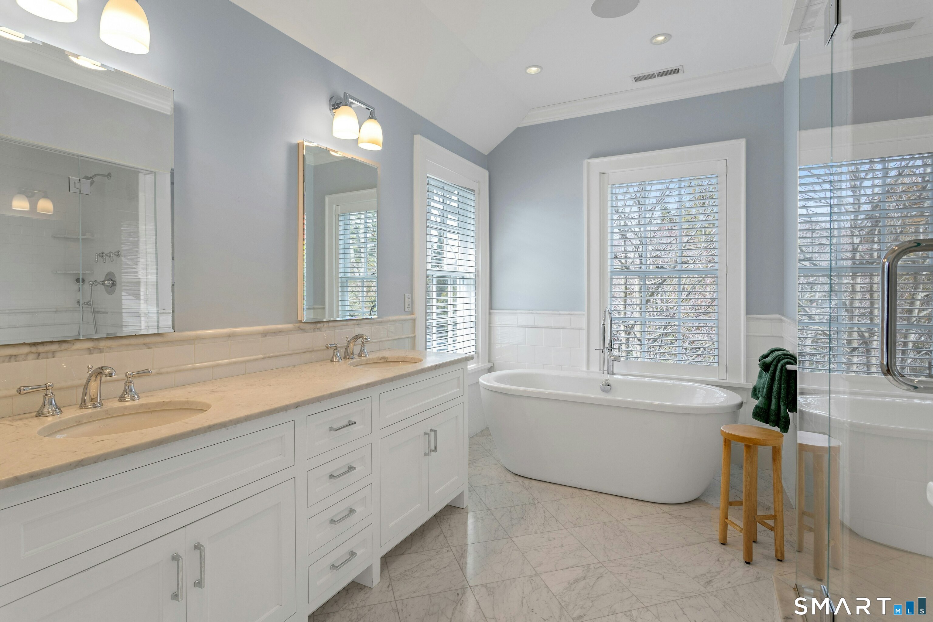 45 Jelliff Mill Road, Unit 45 New Canaan, CT 06840 - Photo 21 of 36 a bath room with a sink double vanity mirror and a bathtub