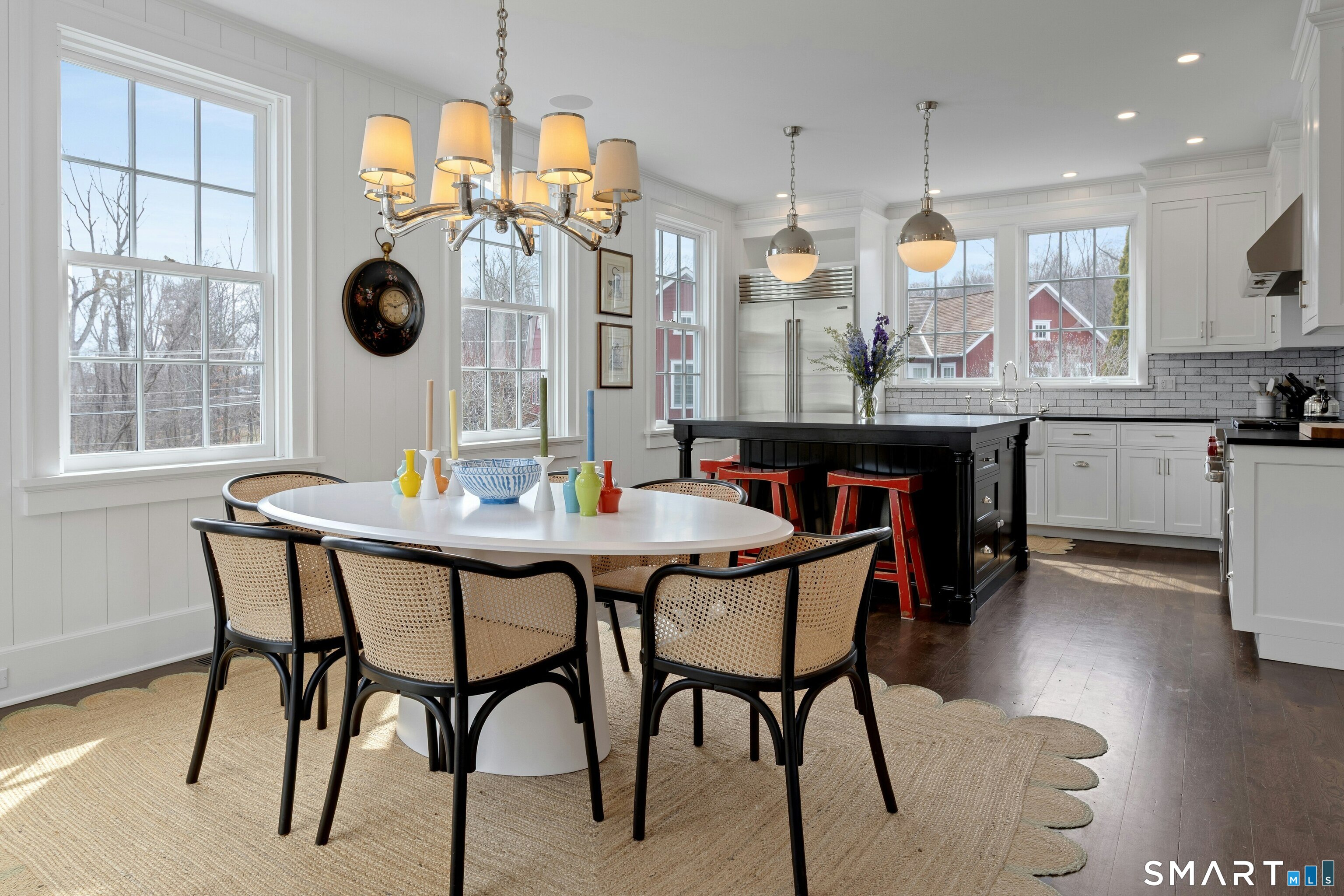 45 Jelliff Mill Road, Unit 45 New Canaan, CT 06840 - Photo 9 of 36 a kitchen with a table chairs and white cabinets