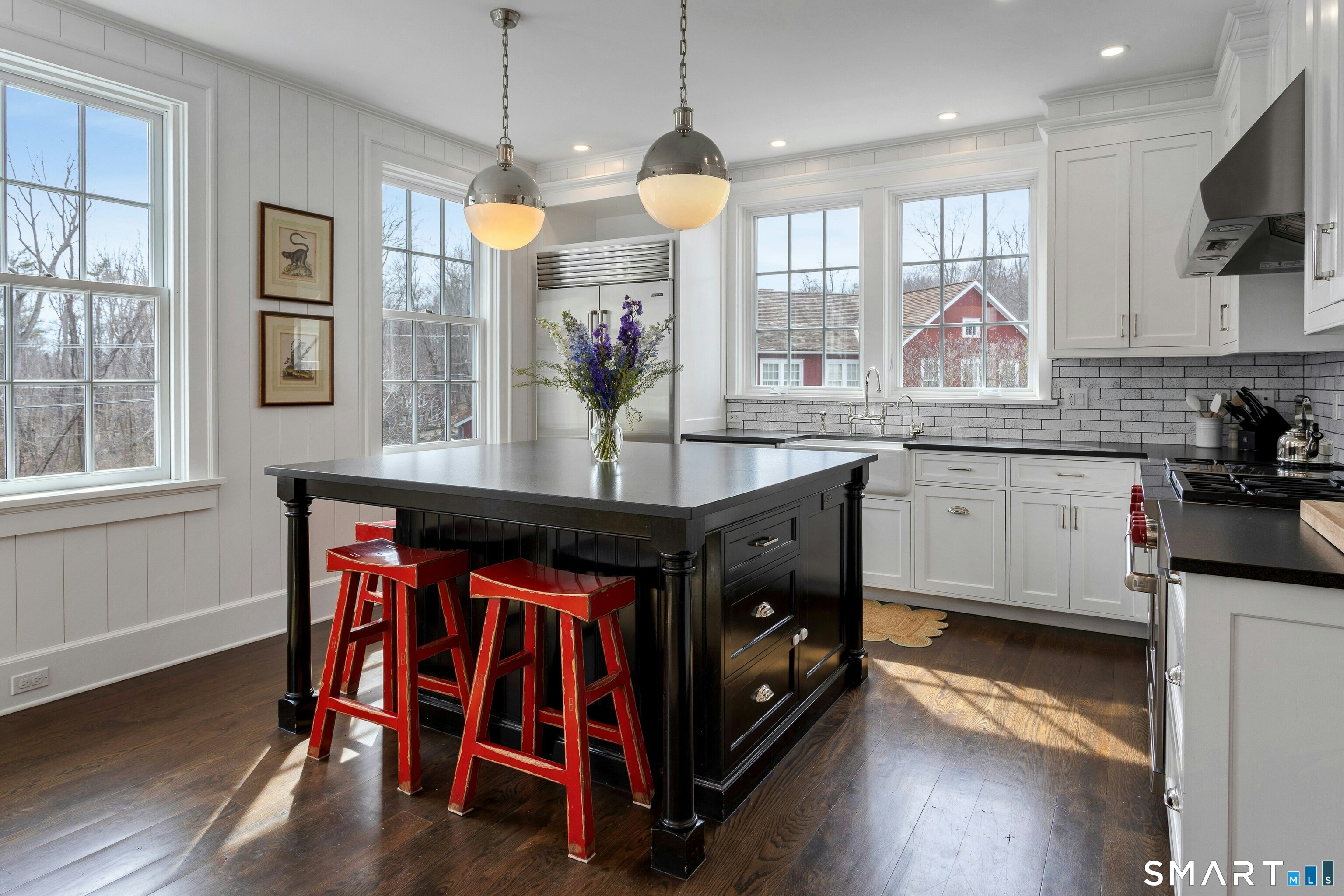 45 Jelliff Mill Road, Unit 45 New Canaan, CT 06840 - Photo 10 of 36 a kitchen with kitchen island granite countertop a stove a sink and a wooden floors