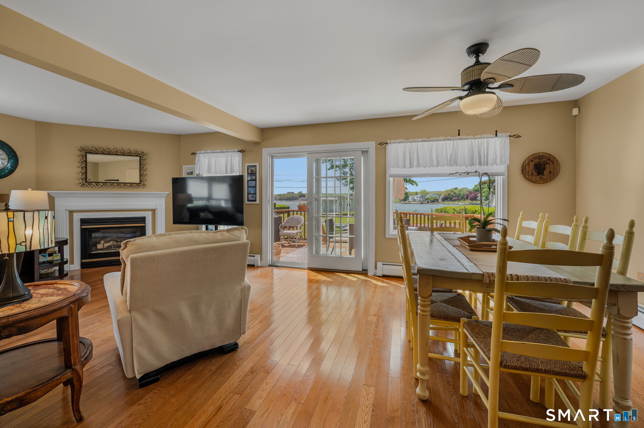 212 R Shore Road Waterford, CT 06385 - Photo 19 of 28 a living room with furniture a fireplace and a flat screen tv