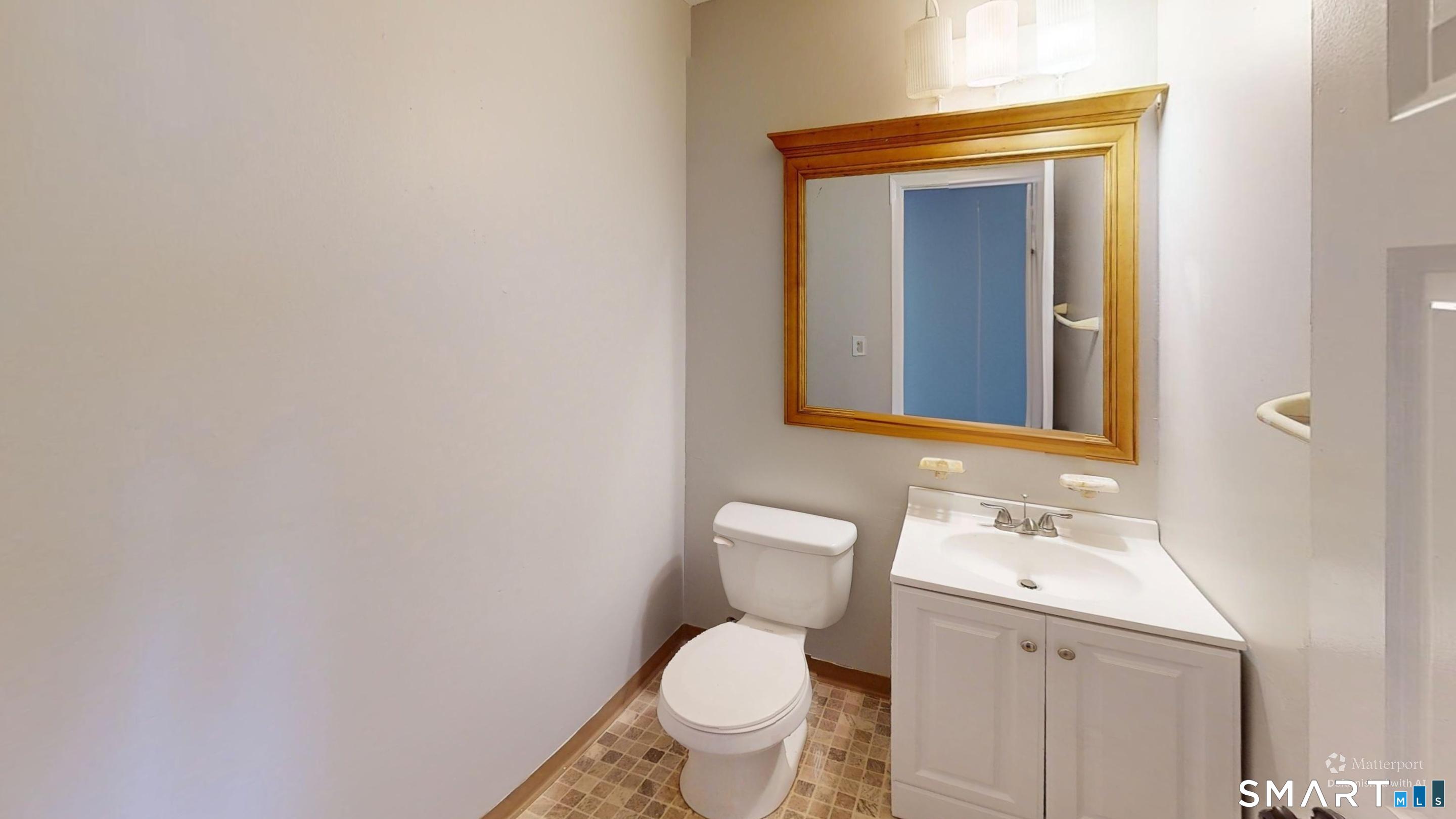 158 High Path Road, Unit 158 Windsor, CT 06095 - Photo 16 of 20 a bathroom with a toilet sink and mirror
