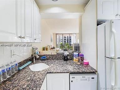 540 Brickell Key Drive, Unit 603 Miami, FL 33131 - Photo 12 of 18 a bathroom with sink and mirror