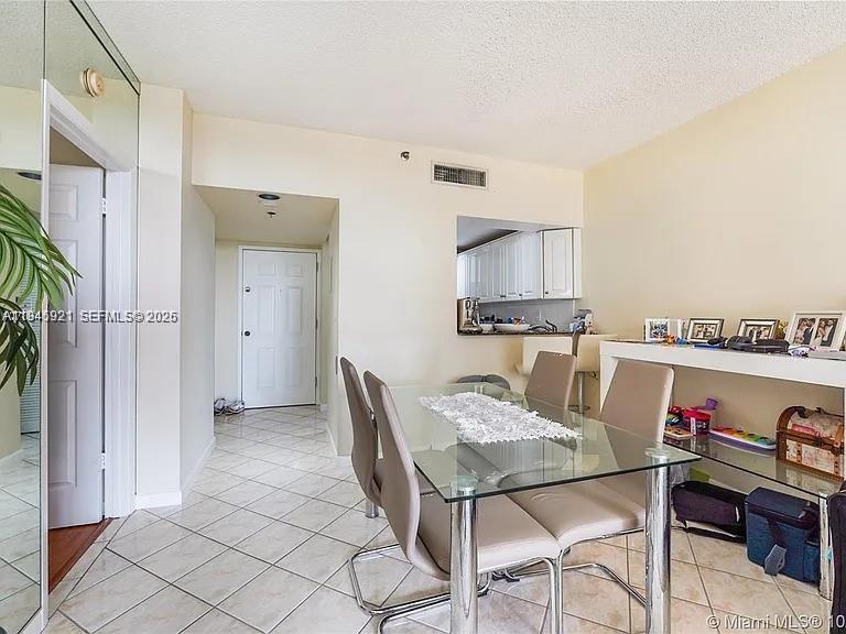 540 Brickell Key Drive, Unit 603 Miami, FL 33131 - Photo 14 of 18 a dining room with furniture and kitchen view